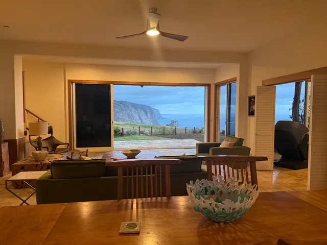 a living room with couches chairs and a large window with outer view