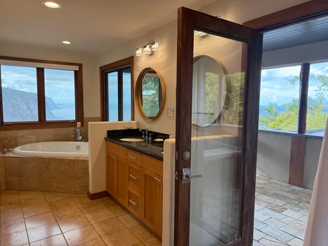a bathroom with a tub sink and mirror
