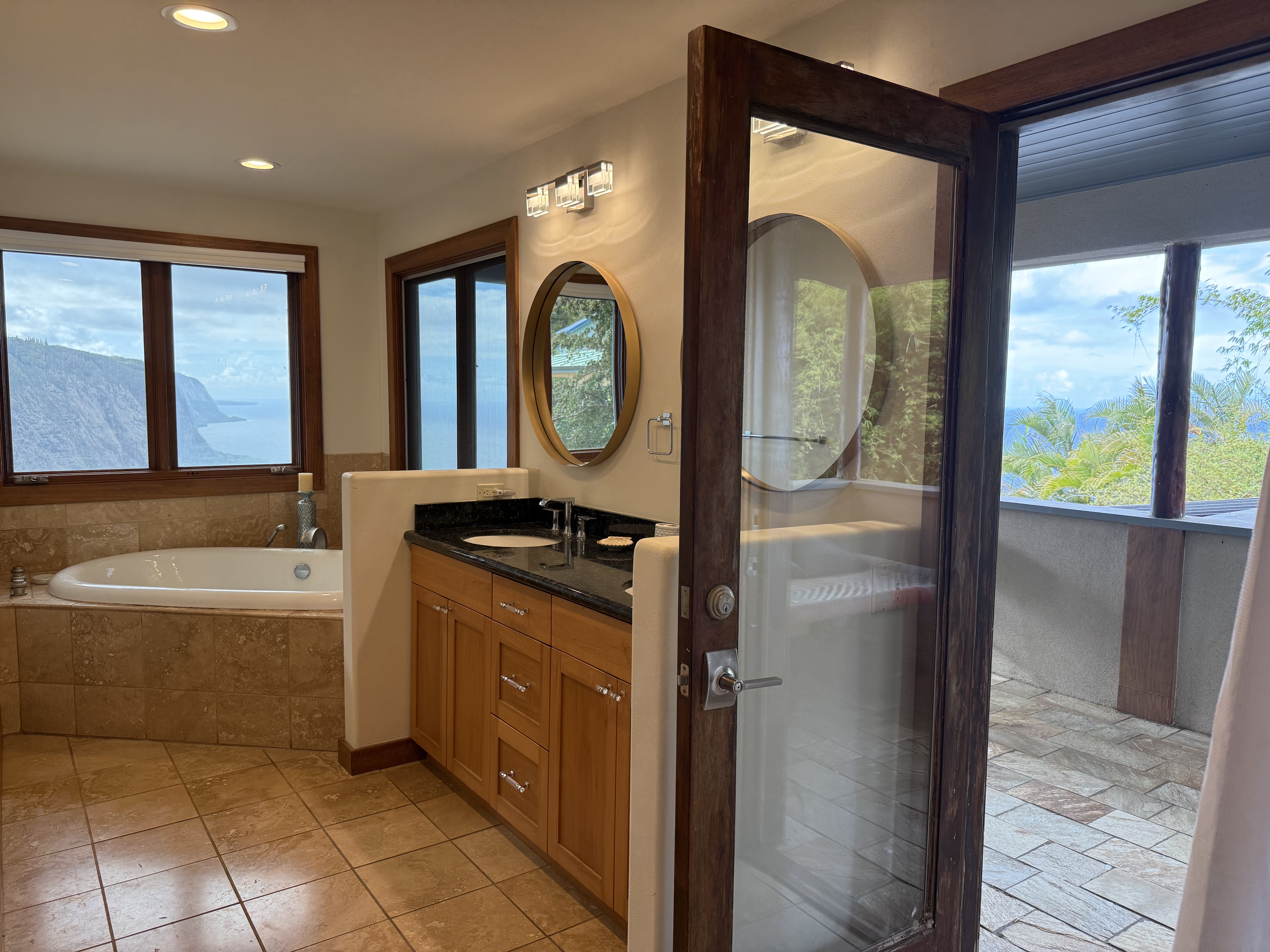48-5528 Waipio Valley Road Honokaa, HI 96727 - Photo 9 of 18 a bathroom with a tub sink and mirror