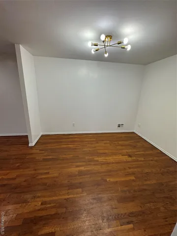 wooden floor and cabinet in an empty room