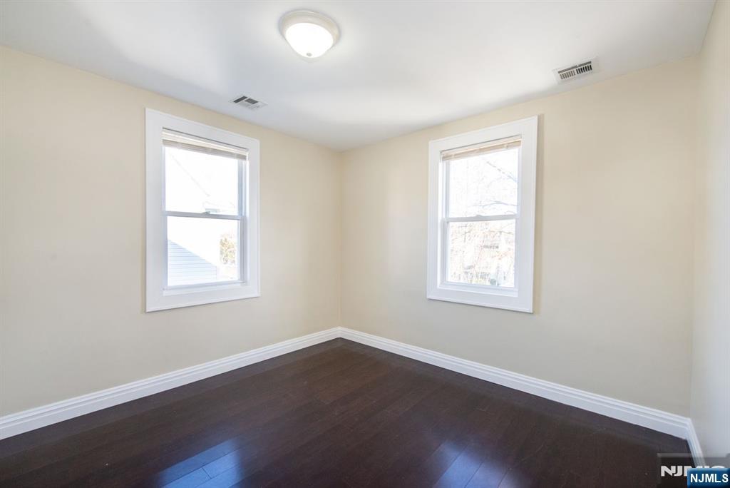 145 Reade Street Englewood, NJ 07631 - Photo 15 of 20 an empty room with wooden floor and windows