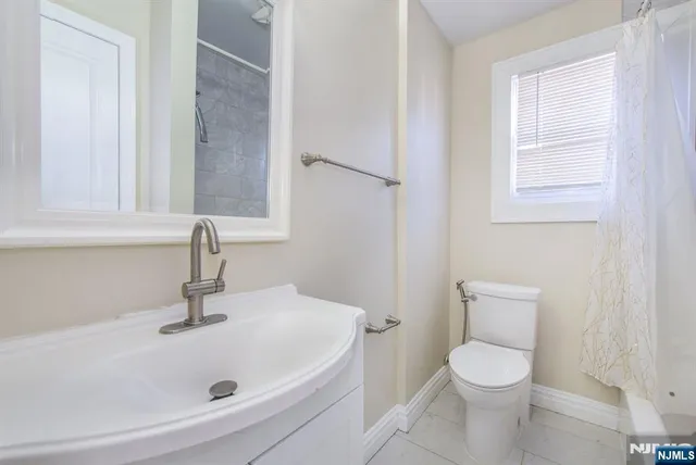 a white bath tub sitting next to a white toilet