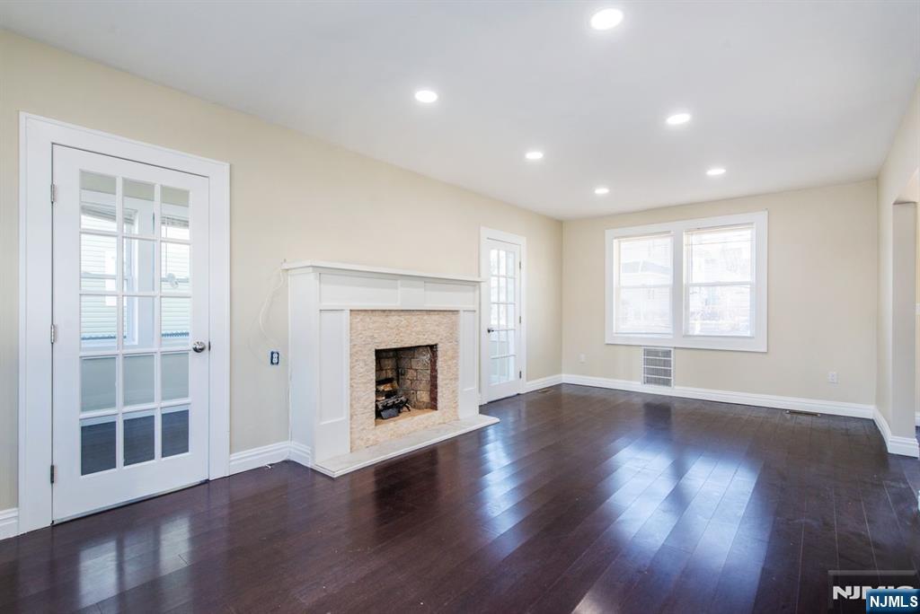145 Reade Street Englewood, NJ 07631 - Photo 4 of 20 a view of an empty room with wooden floor and a window