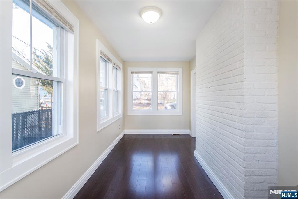 145 Reade Street Englewood, NJ 07631 - Photo 6 of 20 a view of an empty room with wooden floor and a window