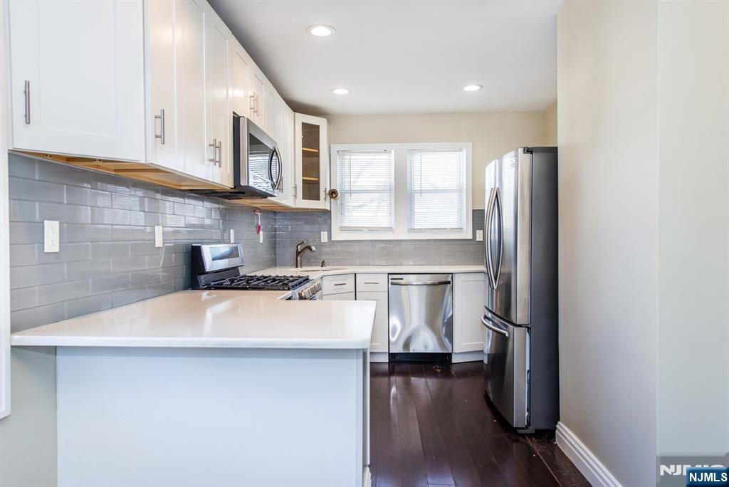 145 Reade Street Englewood, NJ 07631 - Photo 7 of 20 a kitchen with a refrigerator and a sink
