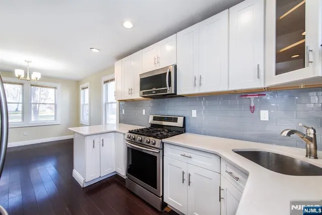 a kitchen with granite countertop wooden cabinets granite counter tops and a stove