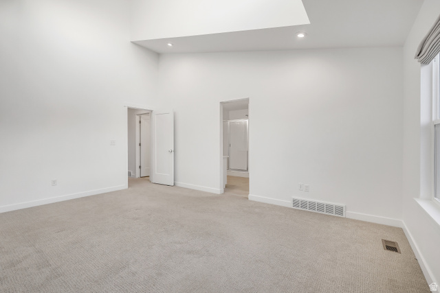 1058 Lilac Way Mapleton, UT 84664 - Photo 11 of 28 Spare room with light colored carpet, recessed lighting, and a high ceiling