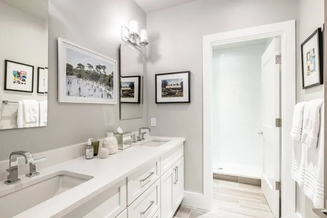 a bathroom with a double vanity sink and a mirror