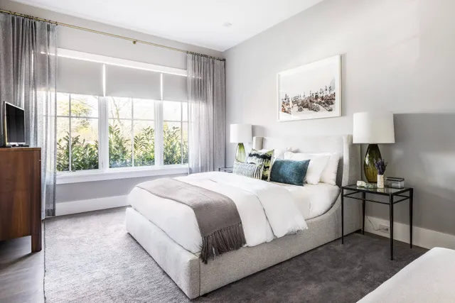 a bedroom with a bed and a large window