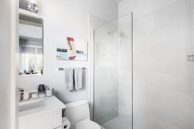 a bathroom with a shower a sink and toilet