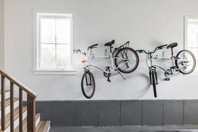 a view of a wooden door with a table and a bicycle