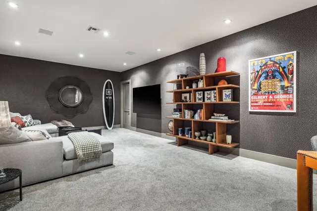 a living room with furniture and a bookshelf
