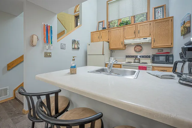 a kitchen with a sink a stove and a dining table