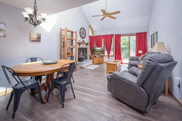 a living room with furniture a chandelier and a window