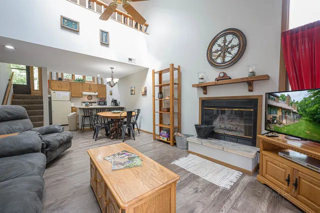 a living room with furniture a clock on wall and a fireplace