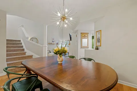 a dining room with furniture and wooden floor