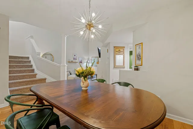 a dining room with furniture and wooden floor