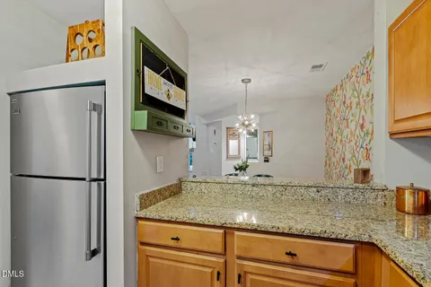 a kitchen with stainless steel appliances granite countertop a refrigerator a oven and a sink