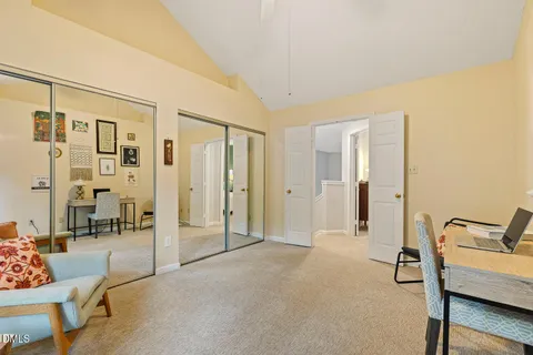 a spacious bedroom with a bed and a chandelier