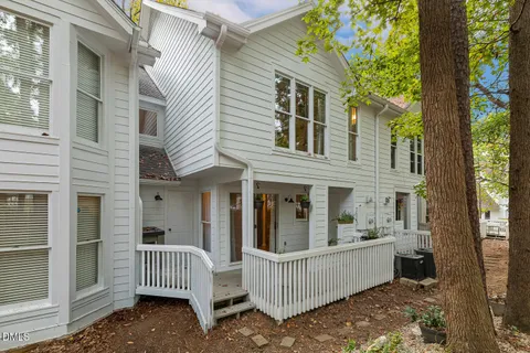 a view of a house with a wooden fence