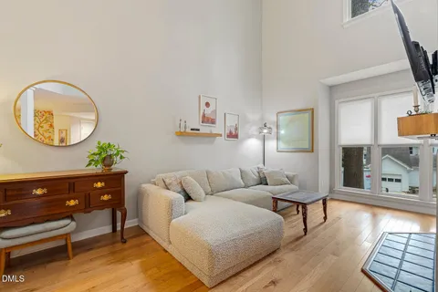 a living room with furniture and a mirror