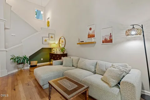 a living room with furniture and wooden floor