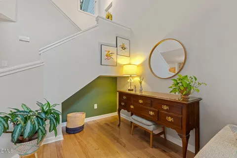 a living room with a potted plant table and a potted plant