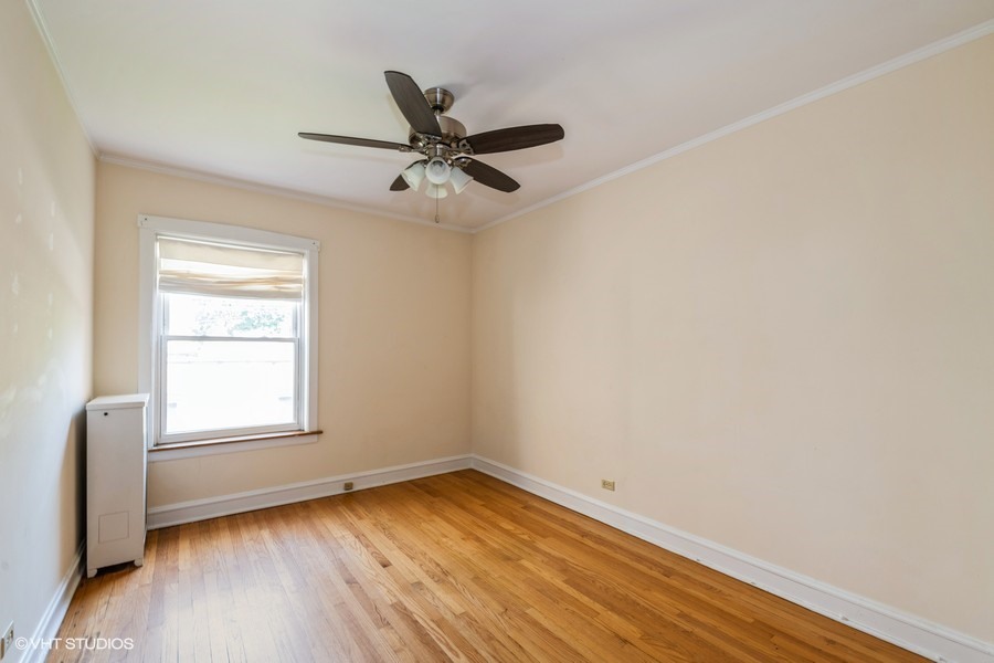 6881 North Overhill Avenue, Unit 1 Chicago, IL 60631 - Photo 11 of 17 wooden floor in an empty room with a window