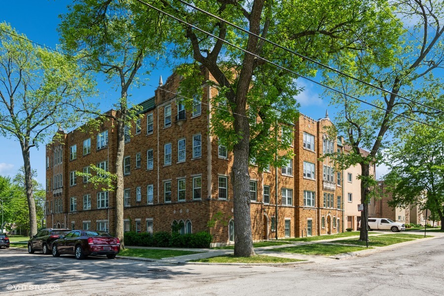 6881 North Overhill Avenue, Unit 1 Chicago, IL 60631 - Photo 14 of 17 a city street lined with buildings and trees