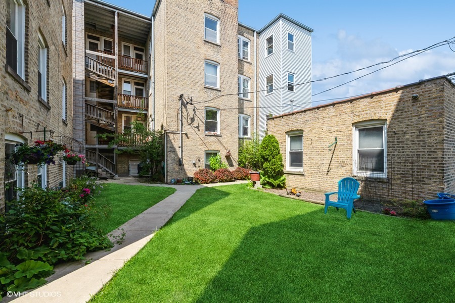 6881 North Overhill Avenue, Unit 1 Chicago, IL 60631 - Photo 16 of 17 a view of an house with backyard space and garden