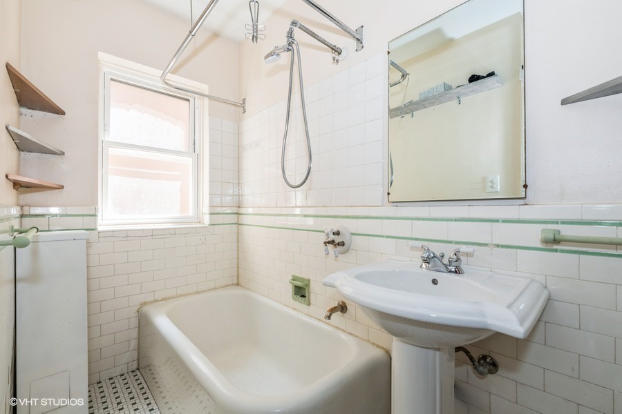 6881 North Overhill Avenue, Unit 1 Chicago, IL 60631 - Photo 9 of 17 a bathroom with a sink a window and shower