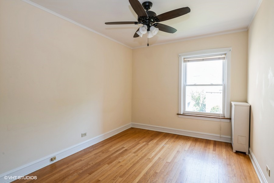 6881 North Overhill Avenue, Unit 1 Chicago, IL 60631 - Photo 10 of 17 an empty room with wooden floor and windows