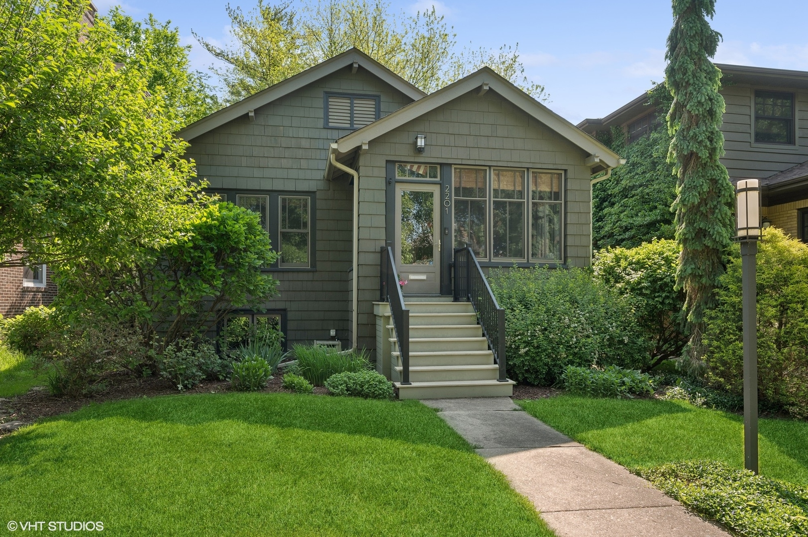 2201 Forestview Road Evanston, IL 60201 - Photo 1 of 27 a front view of a house with a yard and trees
