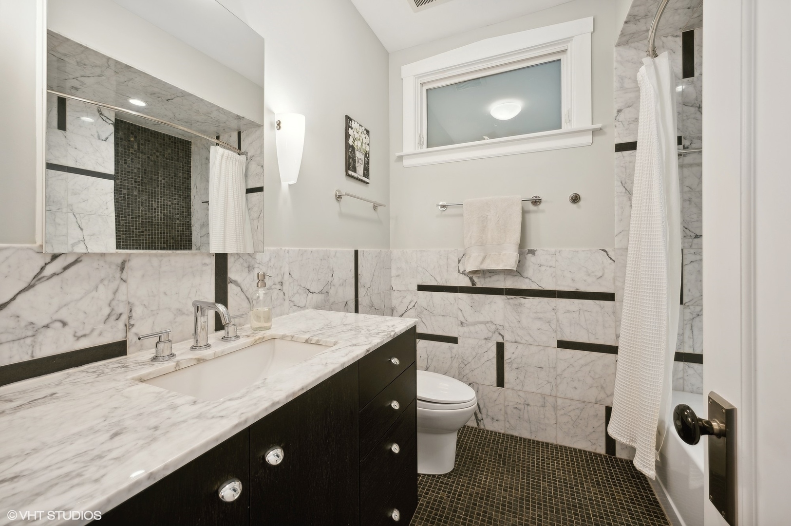 2201 Forestview Road Evanston, IL 60201 - Photo 12 of 27 a bathroom with a granite countertop sink a toilet and a mirror