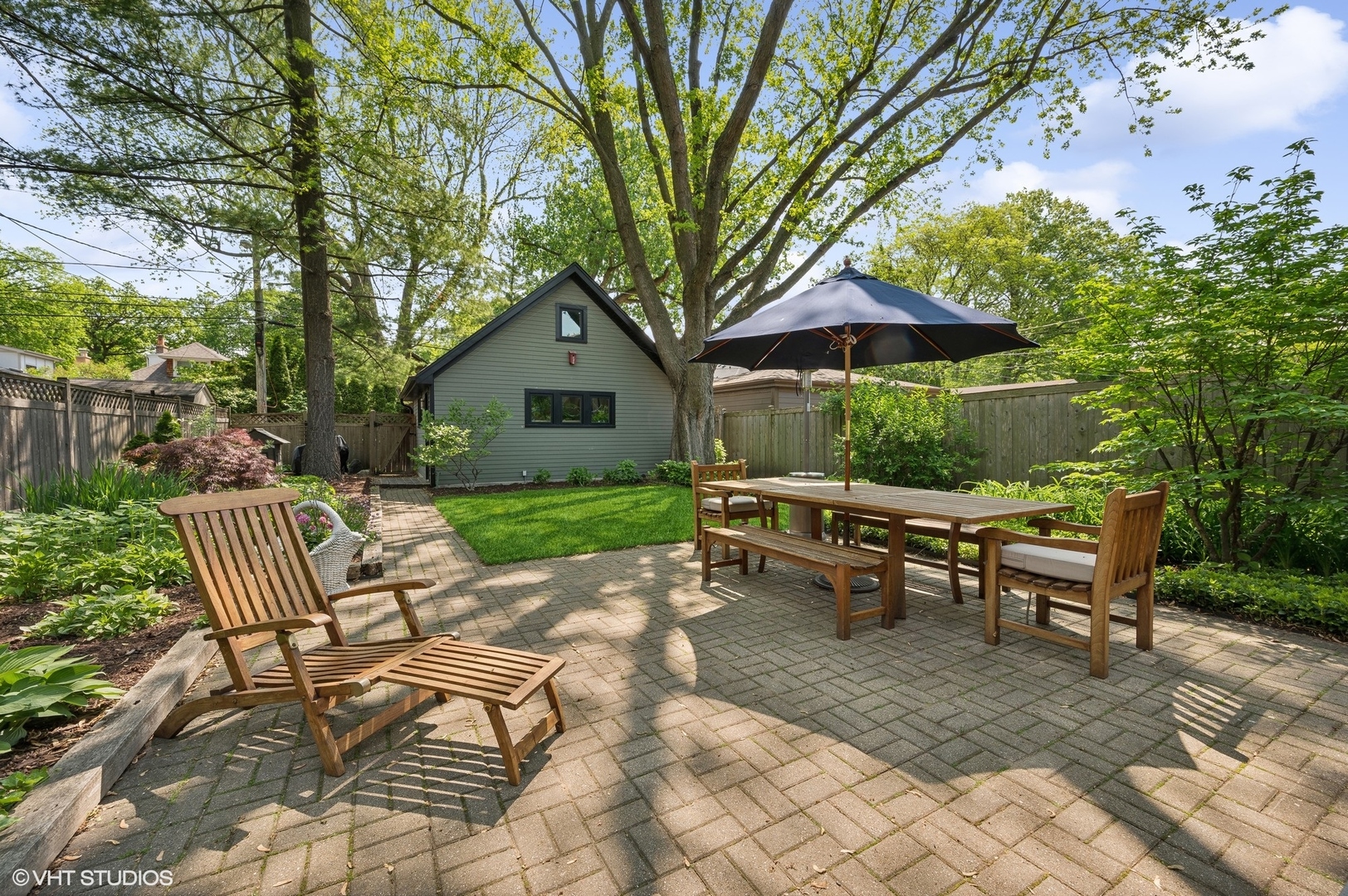 2201 Forestview Road Evanston, IL 60201 - Photo 21 of 27 a view of backyard with table and chairs under an umbrella