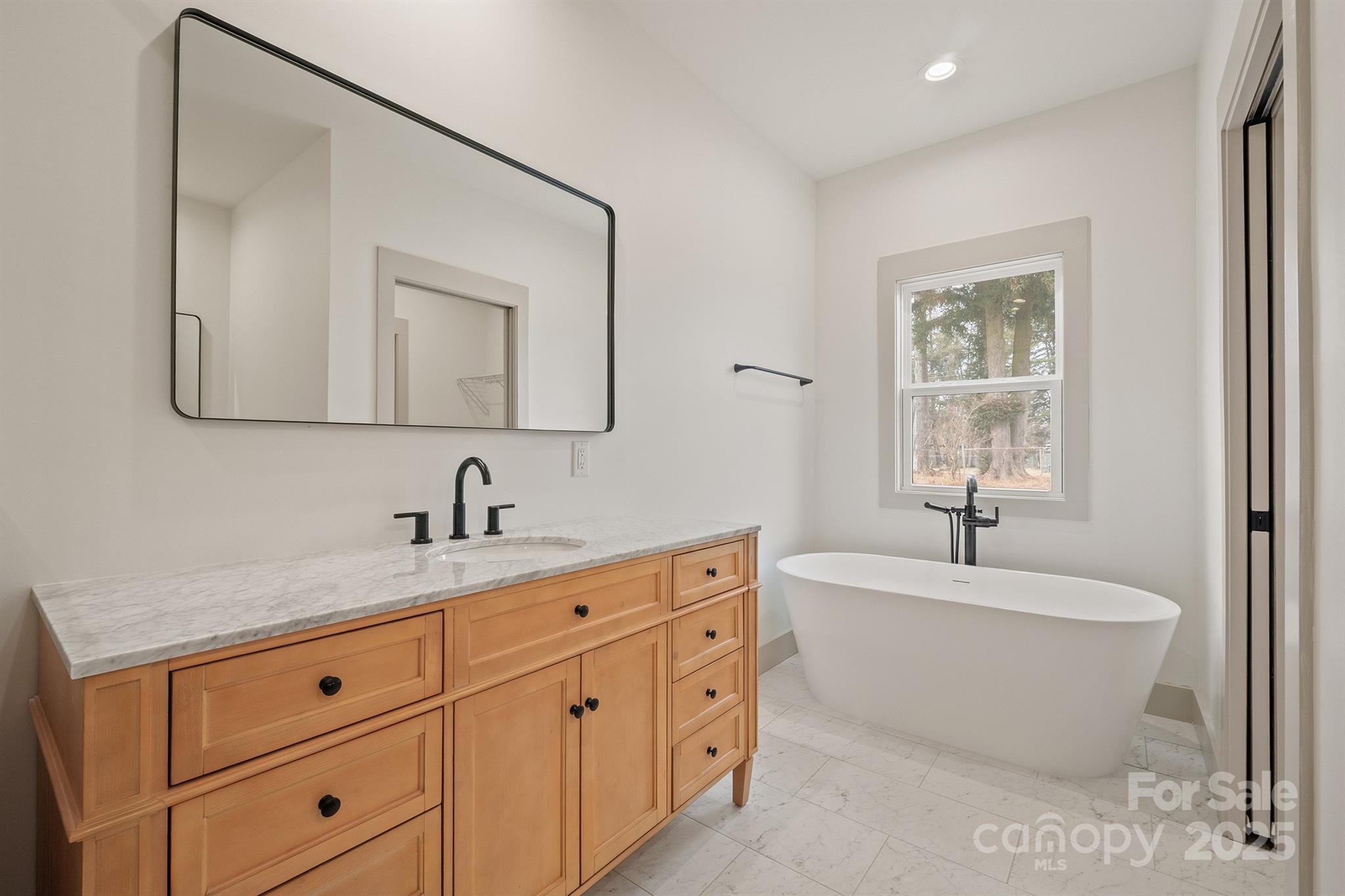 1568 Pleasant Grove Church Road Crouse, NC 28033 - Photo 31 of 48 a spacious bathroom with a double vanity sink a mirror and a bathtub