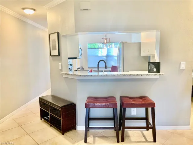 a room with a table chairs and a wooden floor