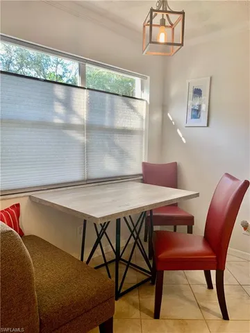 a view of a dining room with furniture and chandelier