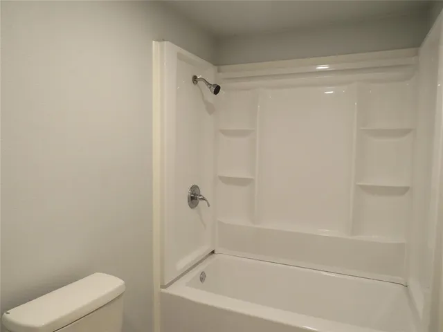 a bathroom with a shower and a toilet