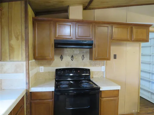 a kitchen with stainless steel appliances granite countertop a stove and a microwave