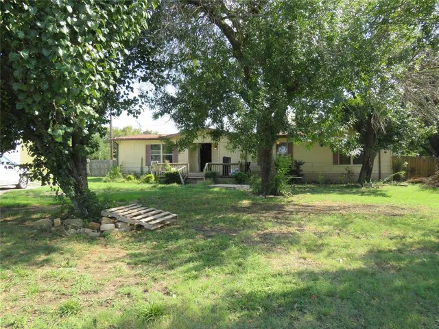 a view of backyard of house with outdoor seating and green space