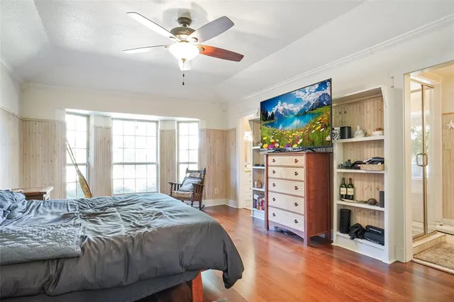 a spacious bedroom with a bed and a window