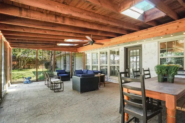 a living room with furniture and floor to ceiling window