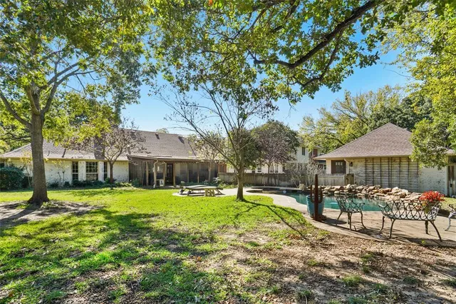 a view of a house with a yard patio and fire pit
