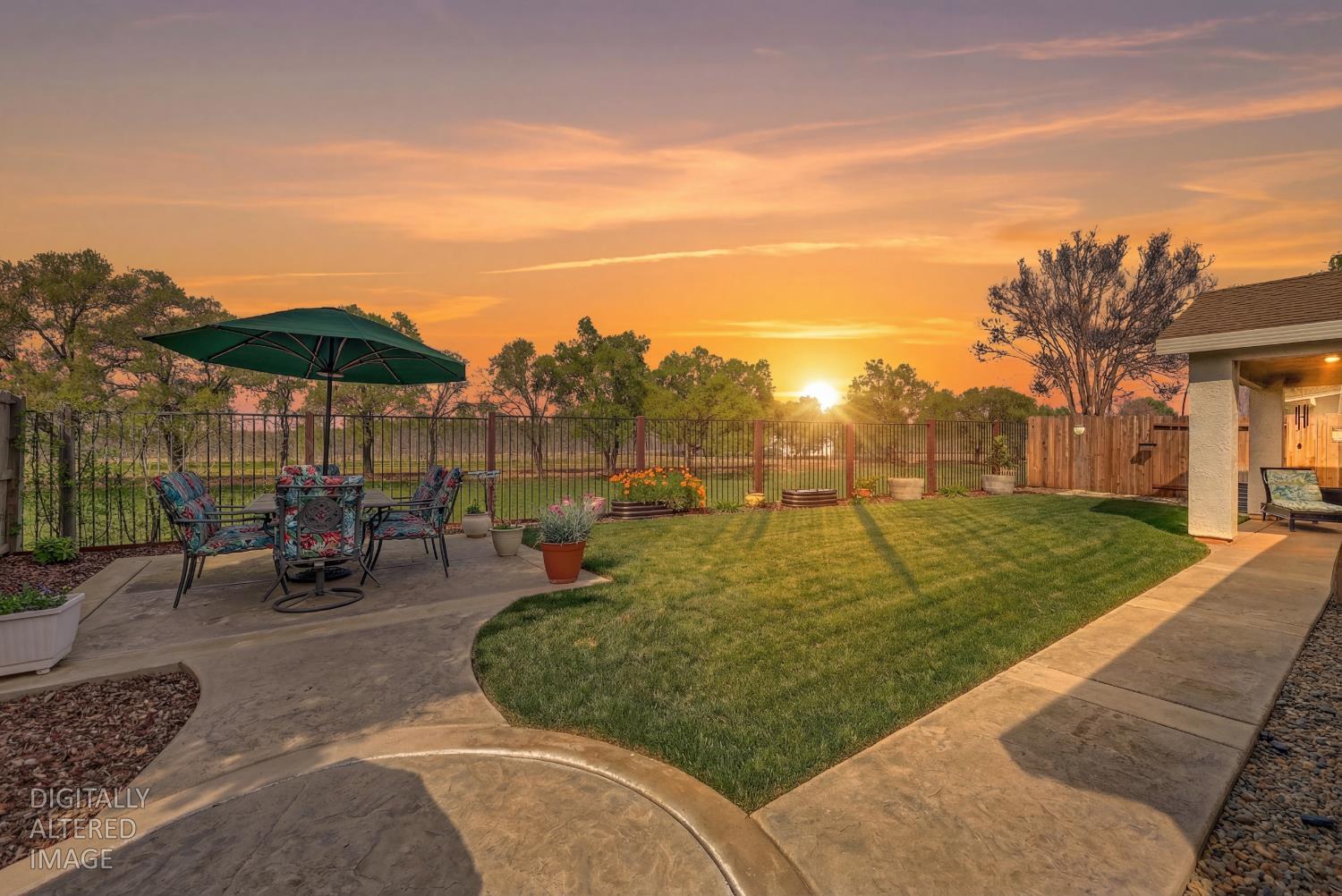 137 Sullivan Way Wheatland, CA 95692 - Photo 54 of 54 Virtual Sunset. Fenced backyard with a patio and outdoor dining area overlooking the greenbelt and orchard