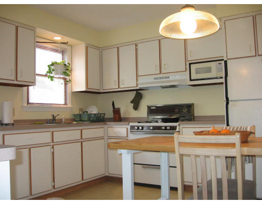 158 Rollins Street Springfield, MA 01109 - Photo 4 of 9 a kitchen with stainless steel appliances granite countertop a stove a sink and a white cabinets