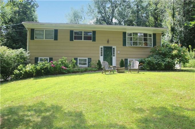 11 North Pleasant Rise Brookfield, CT 06804 - Photo 1 of 1 a front view of house with yard and trees in the background