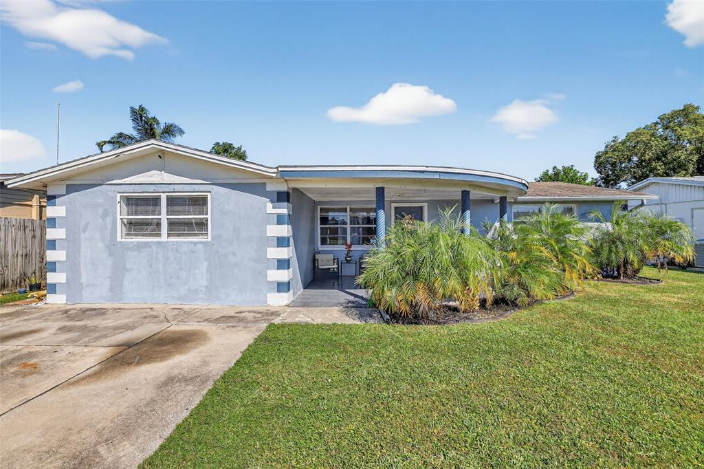 3837 Darlington Road Holiday, FL 34691 - Photo 1 of 28 a front view of a house with a yard and potted plants