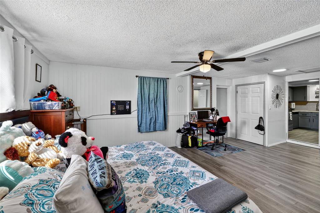 3837 Darlington Road Holiday, FL 34691 - Photo 13 of 28 a bedroom with furniture and a wooden floor