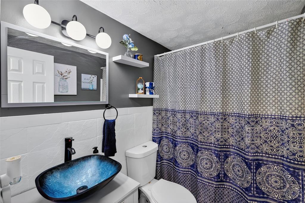 3837 Darlington Road Holiday, FL 34691 - Photo 15 of 28 a bathroom with a toilet mirror and sink